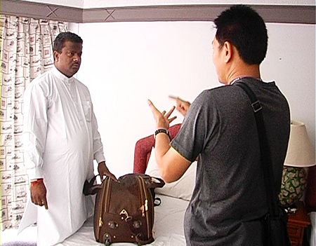 One of the Indian victims, left, talks to authorities about his lost possessions.